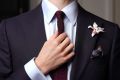 White Orchid Boutonniere with a burgundy knit tie and pocket square