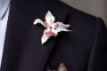 White orchid boutonniere on a navy suit jacket