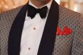 Yellow Gold Studs with carnation, black bow tie and red pocket square with patterned dinner jacket