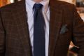 Dark green background with yellow and orange pattern and light blue edge -with navy knit tie