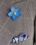 Blue Forget me Not Boutonniere with white purple, green and white silk pocket square all by Fort Belvedere