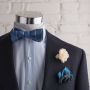 Blue striped jacquard bow tie with ivory spray rose boutonniere and green pocket square with blue borders by Fort Belvedere