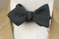 When worn Wool Challis Bow Tie in Brown with Green, Blue, Red & Yellow Pattern - Fort Belvedere