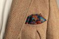 Copper Red Pocket Square Art Deco Egyptian Scarab pattern in royal blue, teal, yellow, with blue contrast edge by Fort Belvedere - Puff fold