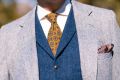 Wool Challis Tie in Sunflower Yellow with Green,Blue and Red Pattern in white long sleeve, blue vest, gray suit and brow & blue silk pocket sqaure
