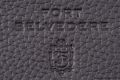 Upclose detail of embossed Fort Belvedere logo on black Togo leather