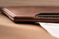 Four Card Carrier Slim Wallet in Saddle Brown Montecristo Leather has smooth corners and has contrast stitching. 