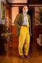 Raphael wearing the goldenrod corduroy pants paired with a yellow knit tie 