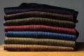 Casually stacked Fort Belvedere Corduroy pants in multiple colors, including the maroon. 
