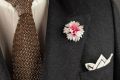 White and Magenta Cornflower Boutonniere Buttonhole Flower Silk combined with Two-Tone Knit Tie in Brown and Beige Changeant Silk, whit linen pocket square in a charcoal colored suit