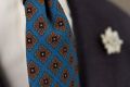 Close up details when worn Wool Challis Tie in Turquoise with Gray, Orange, Navy & Yellow Pattern - Fort Belvedere