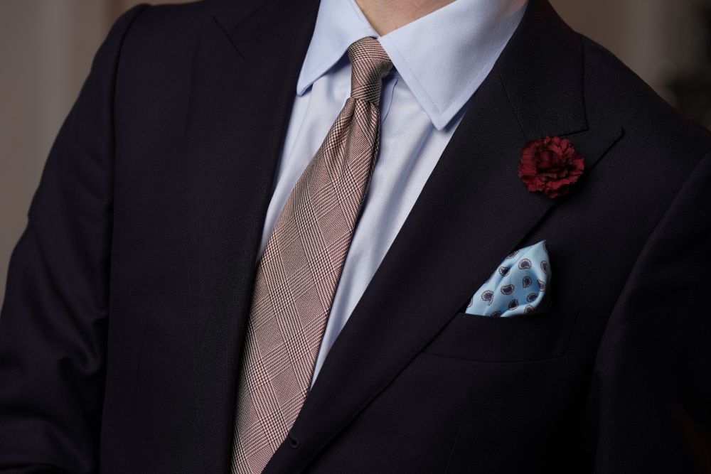 Burgundy Mini Carnation Silk Boutonniere Buttonhole Flower combined with checked tie and blue paisley pocket square