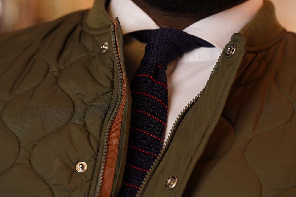 Knit Tie in Solid Navy with Fine Red Stripes, white shirt and green puff jacket