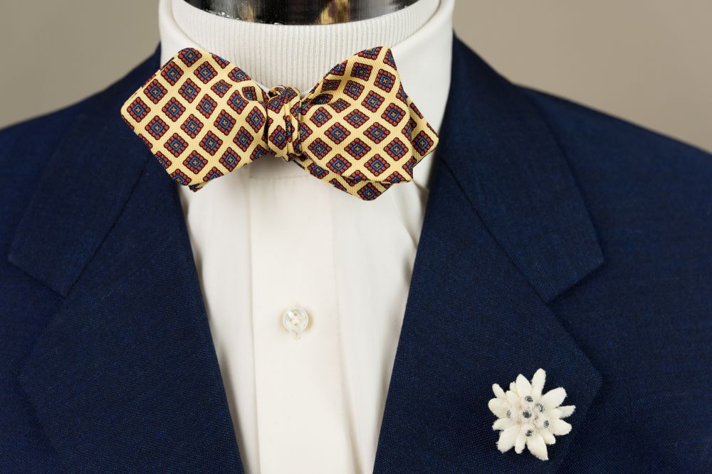 In Action Ancient Madder Silk Bow Tie in Yellow, Red Blue & Orange Diamond Pattern - Handmade by Fort Belvedere