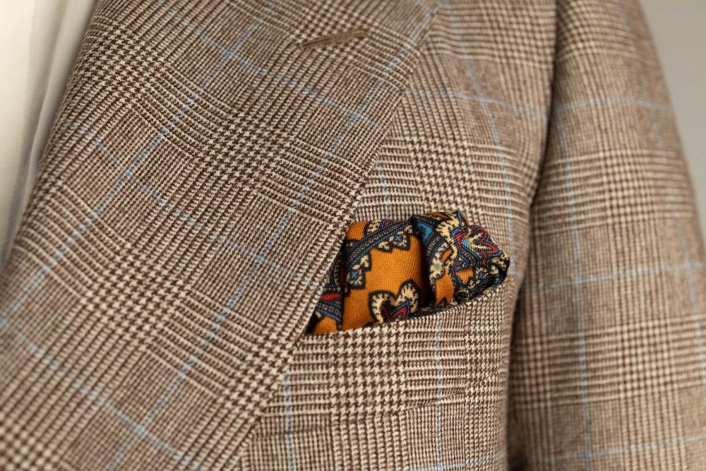 Antique Gold Ochre Silk Wool Pocket Square with Printed geometric medallions in beige, red and blue with cream contrast edge by Fort Belvedere - Puff fold