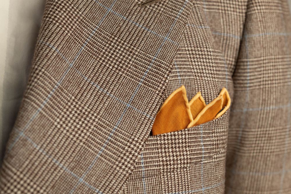 Antique Gold Ochre Silk Wool Pocket Square with Printed geometric medallions in beige, red and blue with cream contrast edge by Fort Belvedere - Crown fold