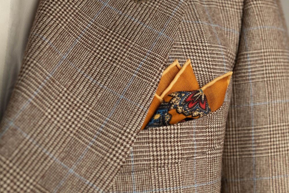 Antique Gold Ochre Silk Wool Pocket Square with Printed geometric medallions in beige, red and blue with cream contrast edge by Fort Belvedere - Crown and Puff mix fold
