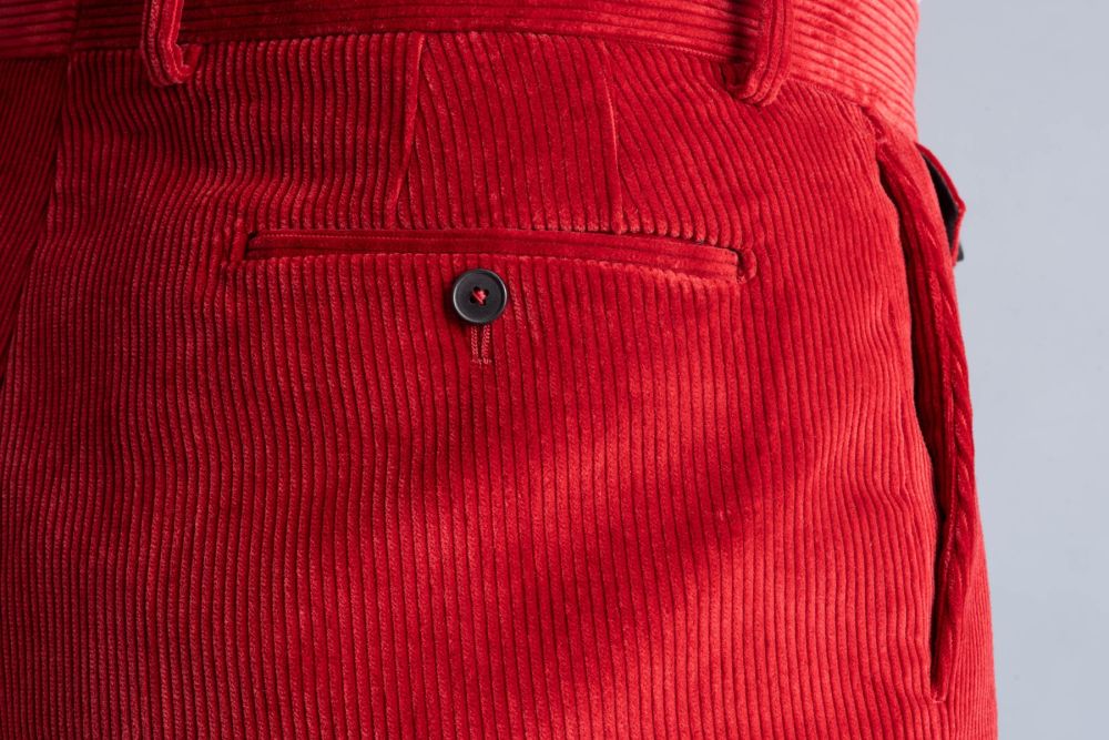 Back pocket detailed view of the Garnet Red Corduroy trousers.