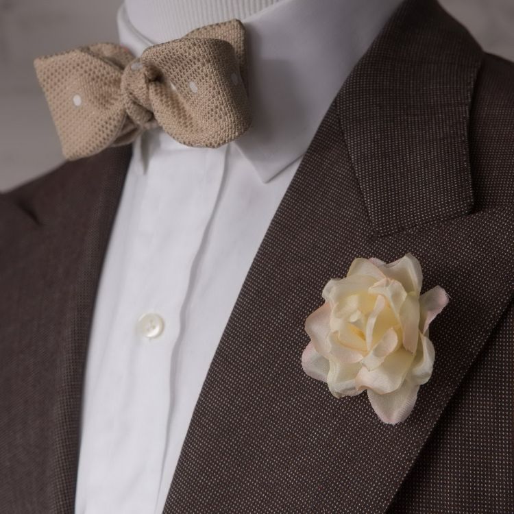 Beige polka dot bow tie, white shirt, ivory spray rose and white shirt by Fort Belvedere
