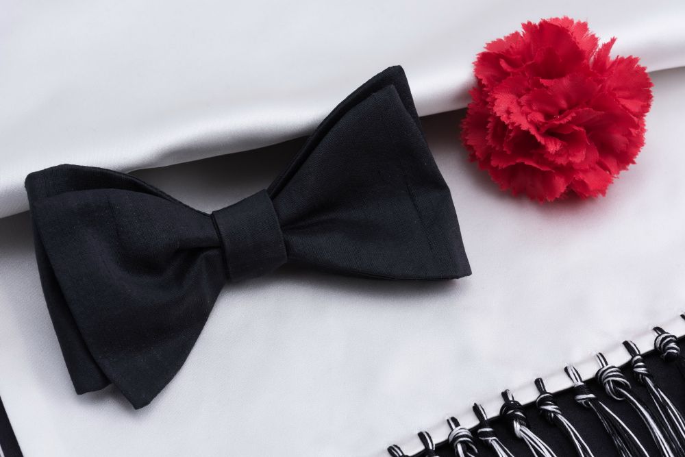 Close up Black Bow Tie in Silk Shantung with Evening Scarf in Black & White Silk Satin and Red Carnation Boutonniere