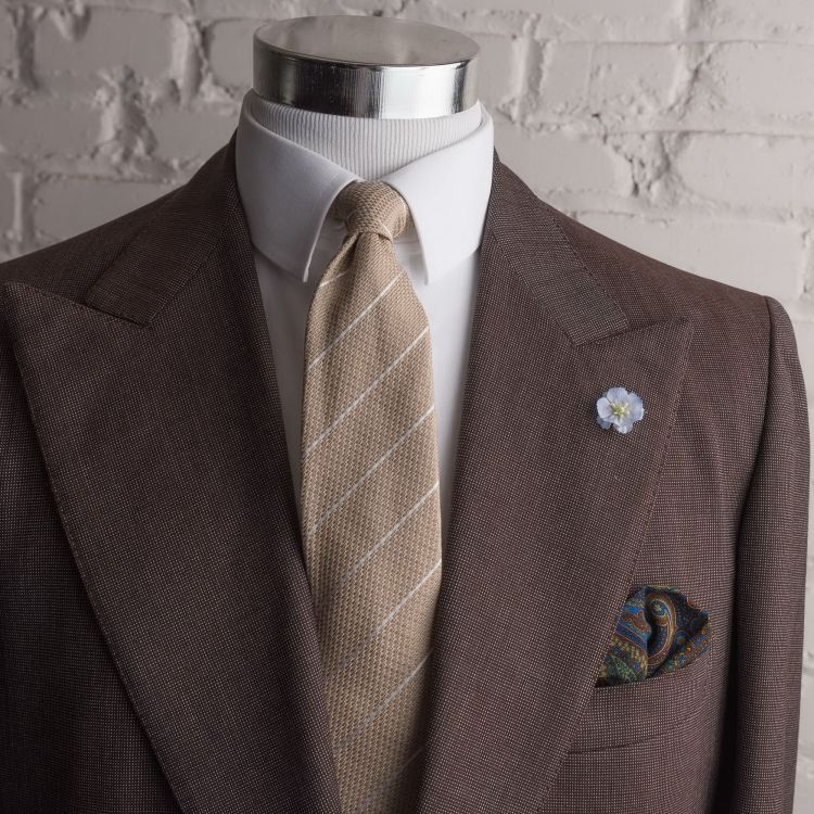 Beige striped tie with blue wool pocket square and blue delphinium boutonniere by Fort Belvedere
