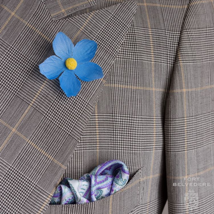 Blue Forget me Not Boutonniere with white purple, green and white silk pocket square all by Fort Belvedere