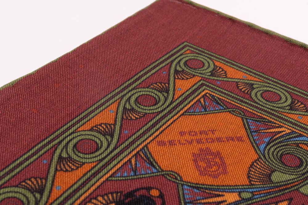 Edge of Brick Red Pocket Square Art Deco Egyptian Scarab pattern in green, orange, yellow, blue with green contrast edge by Fort Belvedere