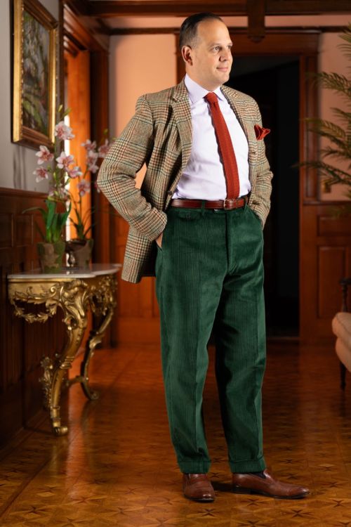 Lifestyle shot of Sven Raphael Schneider with hands in pockets wearing a sport coat outfit with the British Racing Green Corduroy Trousers by Fort Belvedere