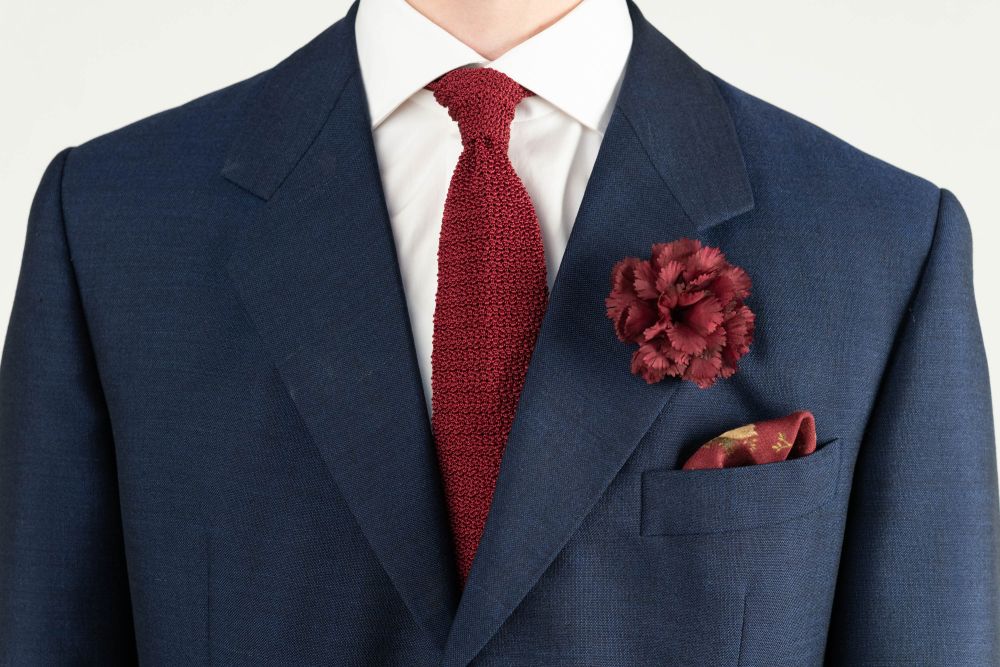 Burgundy Carnation Boutonniere Life Size Lapel Flower paired with Burgundy Knit Tie and Burgundy Silk Pocket Square - all by Fort Belvedere