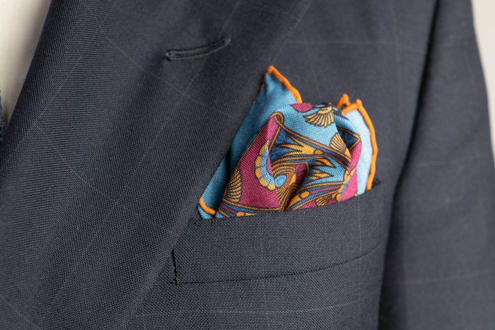 Cerulean Blue Pocket Square Art Deco Egyptian Scarab pattern in burnt orange, magenta, black with orange contrast edge by Fort Belvedere - Crown and Puff mix fold