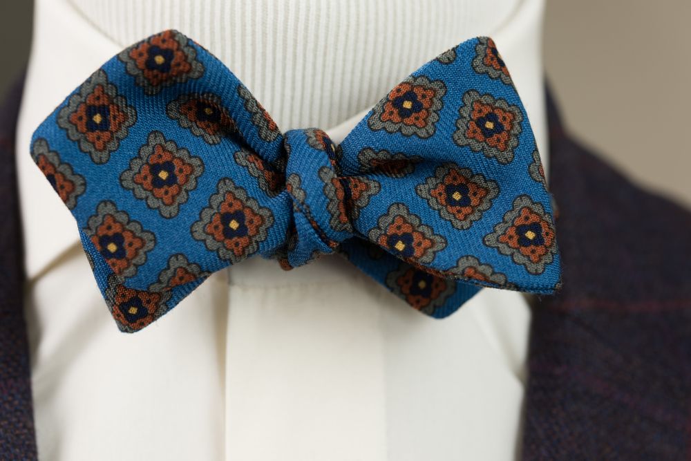 Close up when worn Wool Challis Bow Tie in Turquoise Blue with Green, Orange, Navy & Yellow Diamond - Fort Belvedere