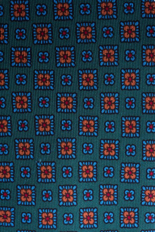 Close up details of Madder Silk Tie in Green with Blue Orange Motif - Fort Belvedere