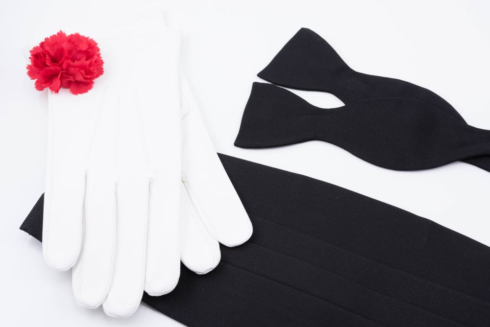Cummerbund in Black Silk Faille Grosgrain with Black bow tie in Silk Faille Grosgrain and Red Carnation Boutonniere and White unlined Leather Gloves-Fort Belvedere