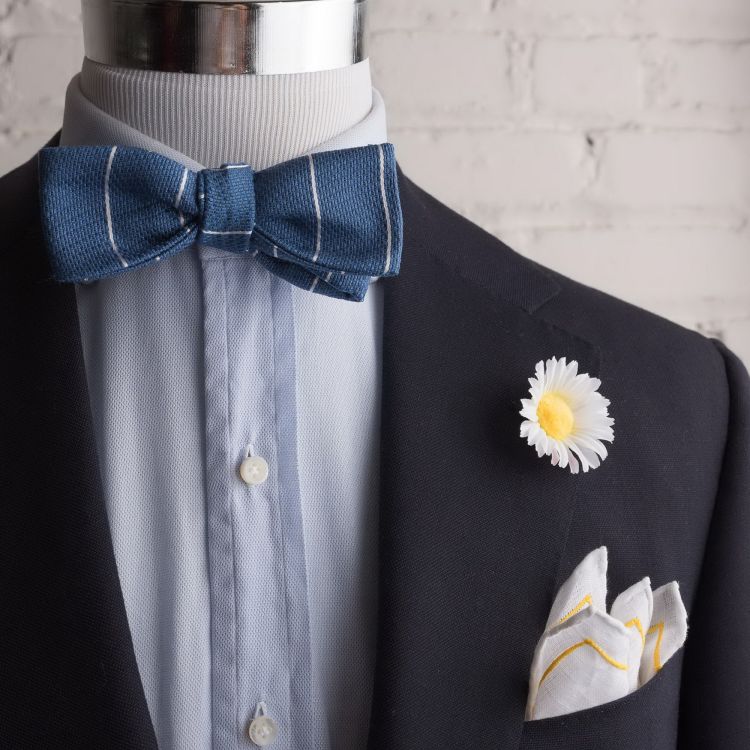 Daisy boutonniere with lined pocket square by Fort Belvedere with blue striped jacquard bow tie by Fort Belvedere