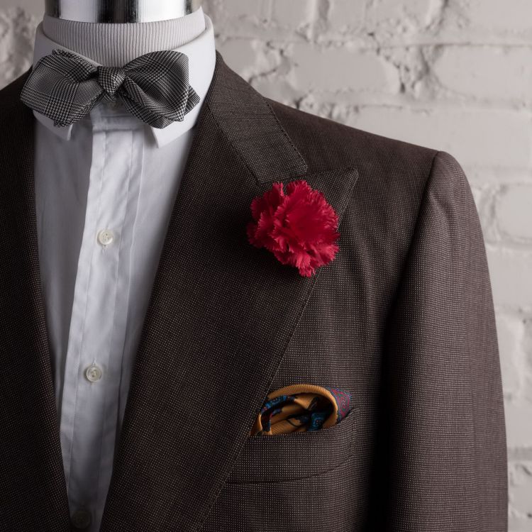 Dark Red Carnation with yellow pocket sqaure and glen check bow tie with pointed ends by Fort Belvedere