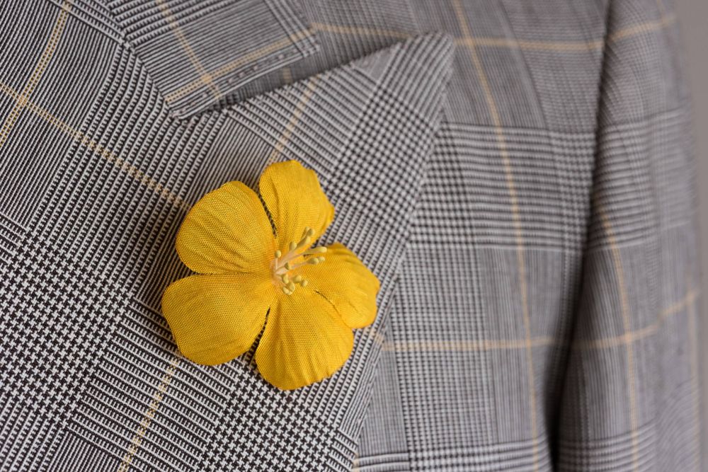 Yellow exotic Flower on Lapel by Fort Belvedere