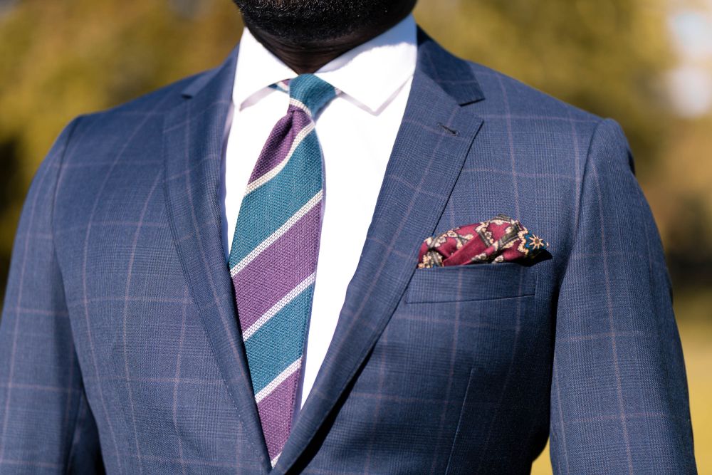 Cashmere Wool Grenadine Tie in Purple, Petrol Blue, Light Grey Stripe combined with white long sleeve, blue suit and burgundy red silk pocket square by Fort Belvedere