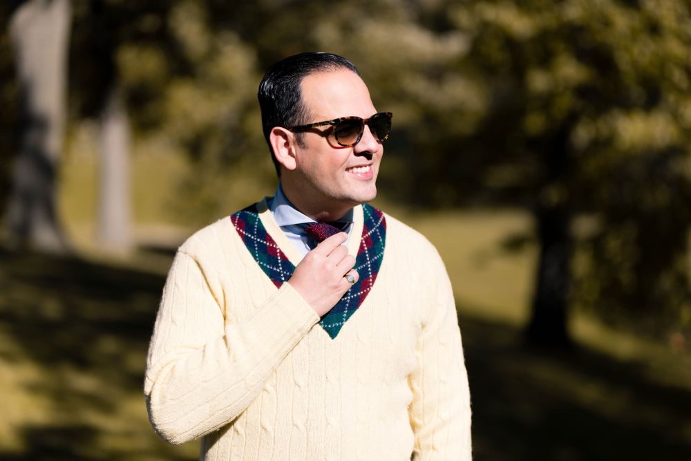 Light blue long sleeve and pale yellow knitted sweater with multi colored collar that matches the Two-Tone Knit Tie in Red and Navy Blue Changeant Silk by Fort Belvedere