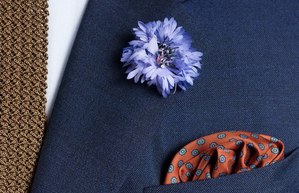 Folded Burnt Orange Silk Pocket Square with Dotted Motifs & Paisley and Blue Cornflower Boutonniere - Fort Belvedere
