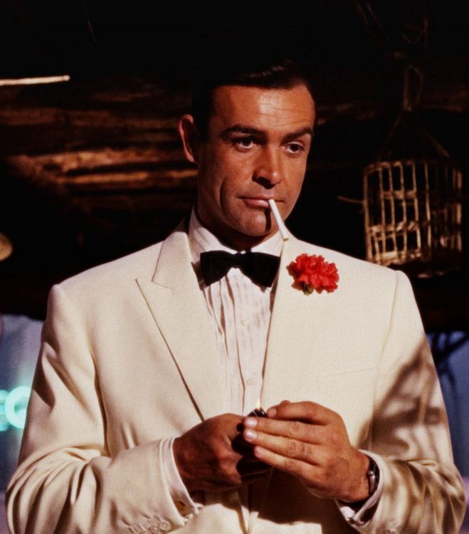 James Bond with red carnation boutonniere flower and white dinner jacket