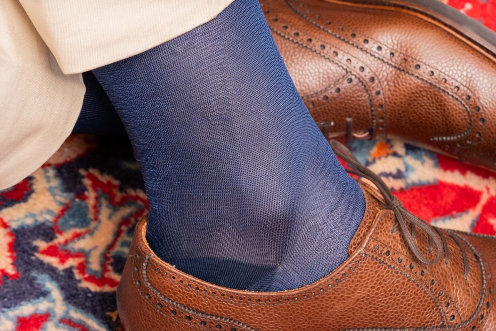 Detail shot of brown full brogues paired with Over the Calf Silk Socks in Light Navy by Fort Belvedere
