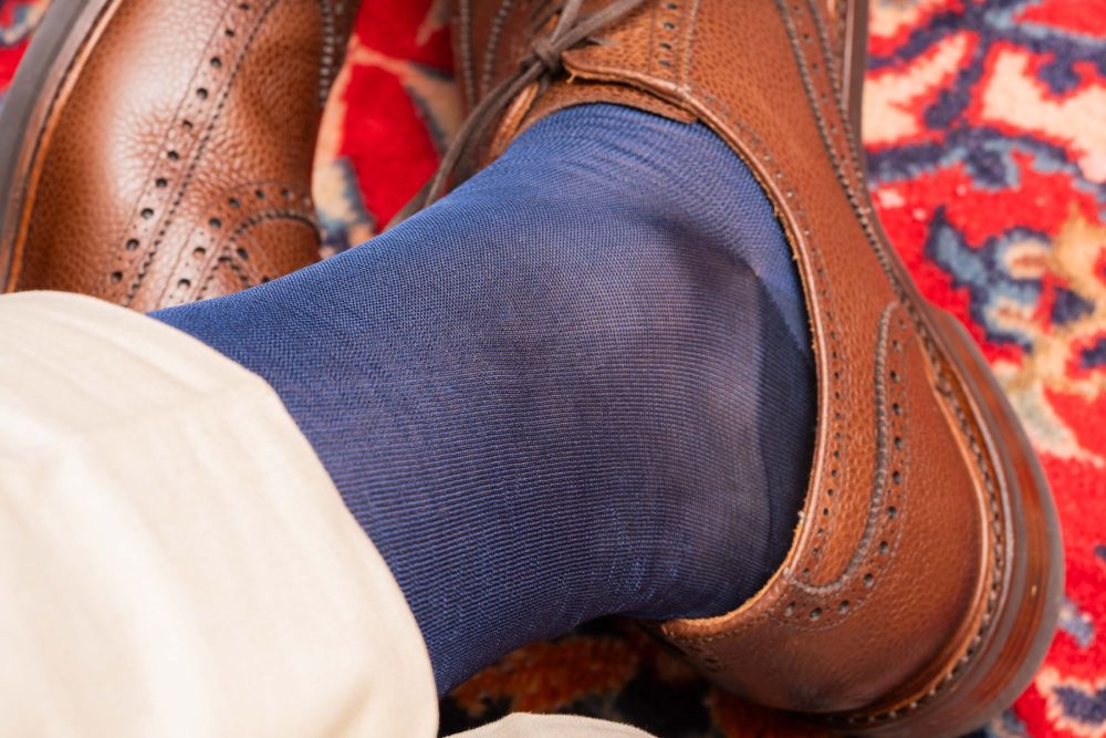 Up-close shot of brown full brogues paired with Over the Calf Silk Socks in Light Navy by Fort Belvedere