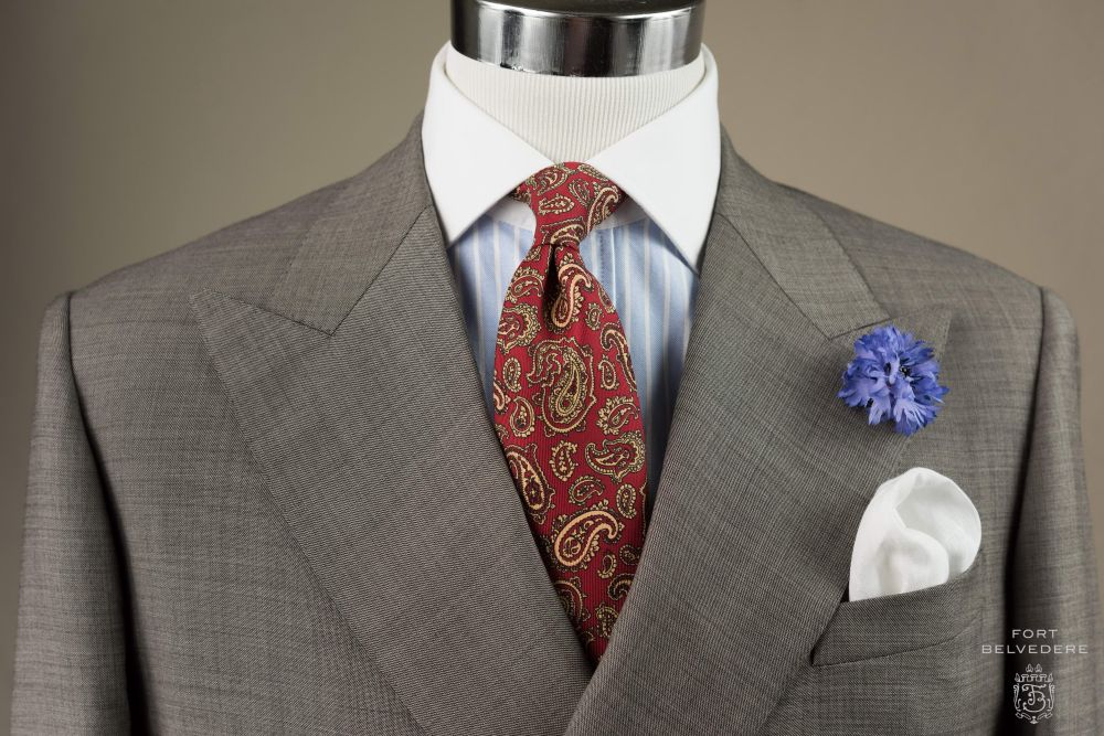 Madder Silk Tie in Red with Buff Paisley combined with Blue Cornflower Boutonniere & Classic White Pocket Square - Fort Belvedere