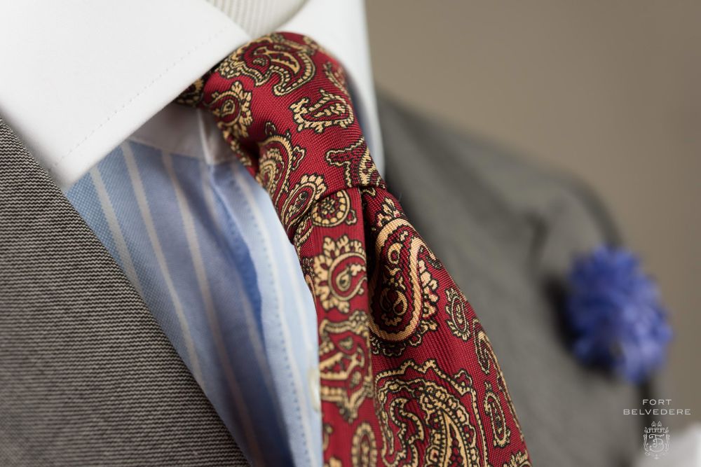 Madder Silk Tie in Red with Buff Paisley combined with Blue Cornflower Boutonniere side view- Fort Belvedere 