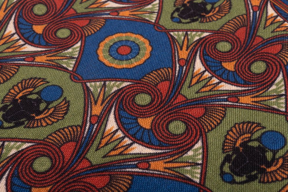 Fabric details of Olive Green Pocket Square Art Deco Egyptian Scarab pattern in burnt orange, sunflower yellow, mohair blue with burnt orange contrast edge by Fort Belvedere