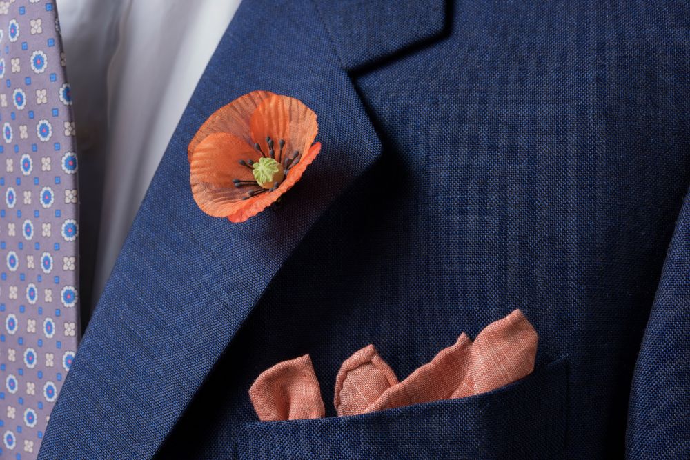 Orange Poppy Boutonniere with linen wool pocket and silk foulard tie  all by Fort Belvedere