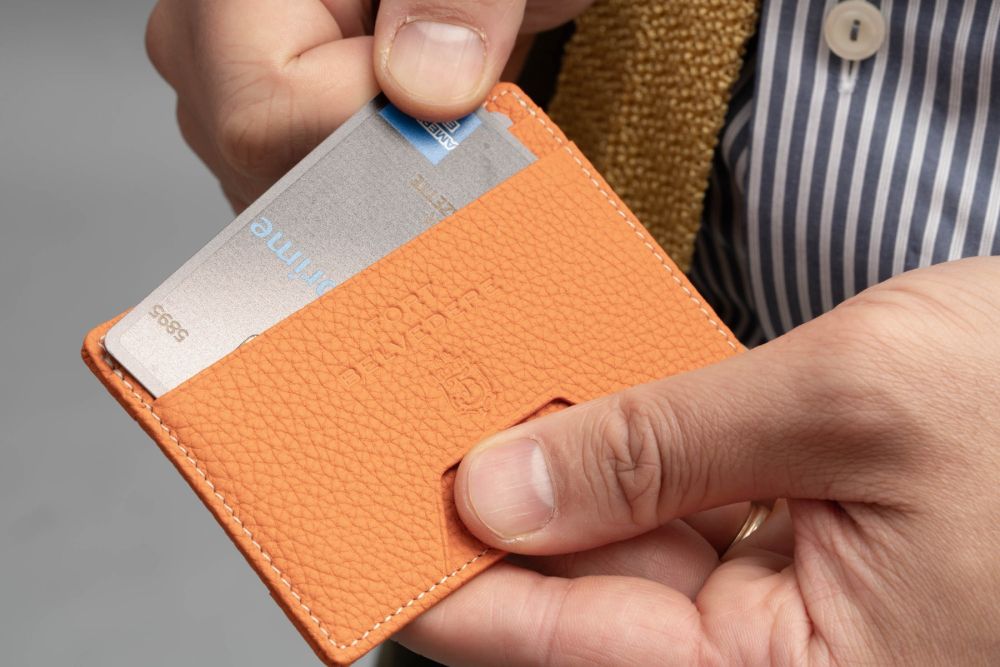 Orange Togo Full-Grain Leather 4CC Wallet has RFID blocking.