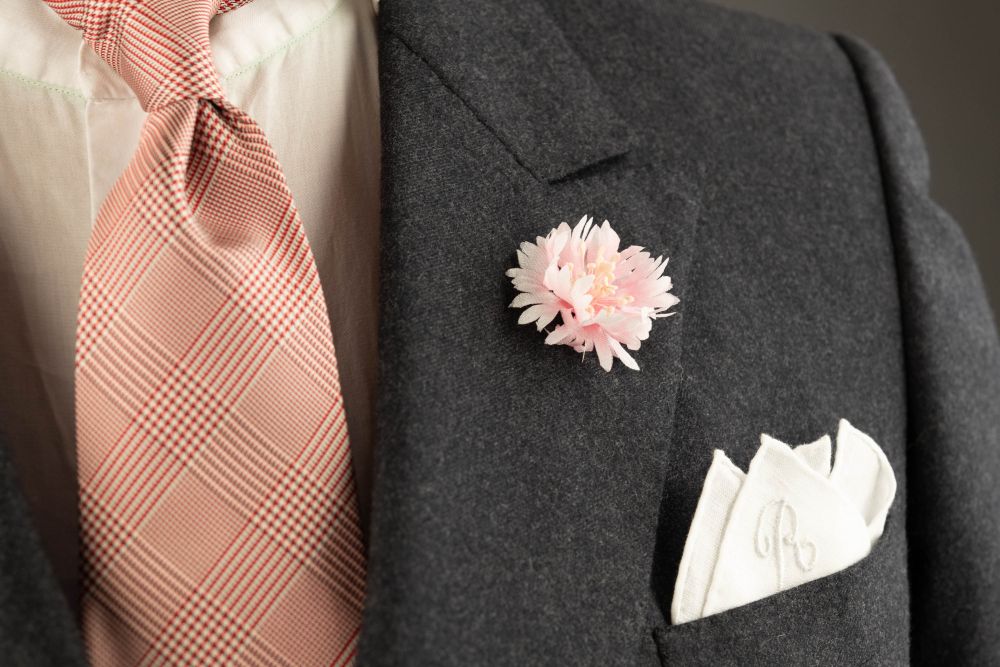 Pink Cornflower Boutonniere Buttonhole Flower Silk Fort Belvedere with white pocket square and Prince of Wales Glen Check Silk Tie in Burgundy and White