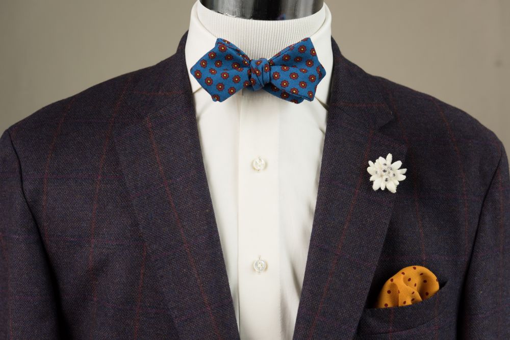 Wool Challis Bow Tie in Mohair Blue with Red & Yellow Pattern paired with Edelweiss Boutonniere ^ Yellow Pocket Square with Burgundy Polka Dots - Handmade by Fort Belvedere