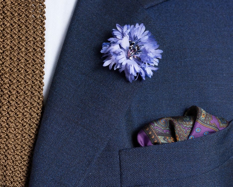 Folded Purple Silk Pocket Square with Dotted Motifs & Paisley adn Blue Cornflower Boutonniere with Knit Tie in Tobacco Brown Silk